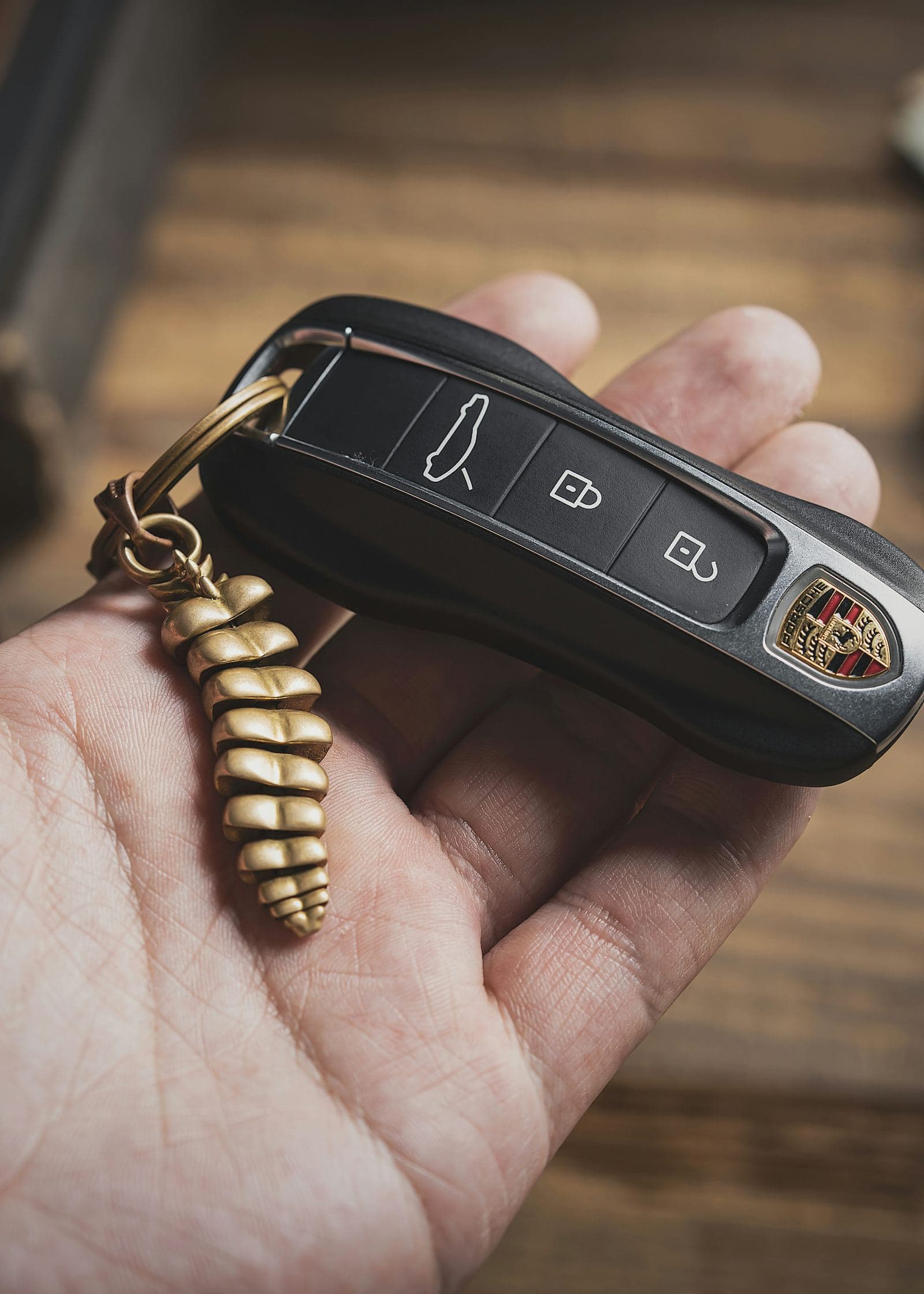 Driver holding a car key that won't turn in the ignition, close-up on hand.